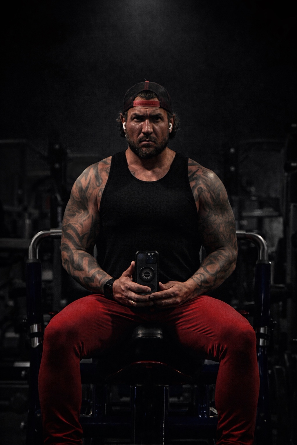 Eric Madden seated in a dark gym
